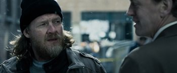 Movie still from “Max Payne” (2008), directed by John Moore – A man with long hair and a beard is standing in the street; Close Up shot, Over the shoulder angle