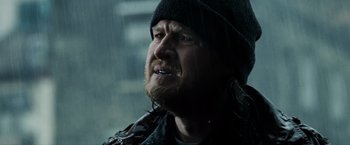Movie still from “Max Payne” (2008), directed by John Moore – A person wearing a hat and a jacket; Close Up shot, Over the shoulder angle