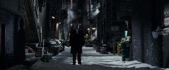 Movie still from “Max Payne” (2008), directed by John Moore – A man standing in the middle of a snowy street; Wide shot, Low angle