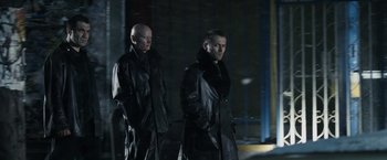 Movie still from “Max Payne” (2008), directed by John Moore – Two men in black leather jackets standing next to each other; Medium shot, Low angle