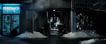 Movie still from “Max Payne” (2008), directed by John Moore – A man standing in a tunnel with snow on the ground; Wide shot, High angle