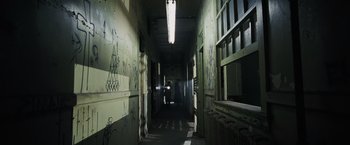 Movie still from “Max Payne” (2008), directed by John Moore – A person is walking down a hallway in a building; Extreme Wide shot, High angle