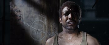 Movie still from “Max Payne” (2008), directed by John Moore – A person with a face covered in dirt; Close Up shot, Low angle