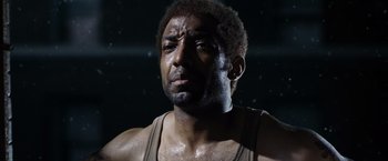 Movie still from “Max Payne” (2008), directed by John Moore – A person wearing a tank top; Close Up shot, Low angle