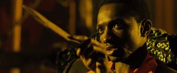 Movie still from “Max Payne” (2008), directed by John Moore – A person holding a microphone; Close Up shot, Low angle