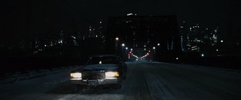 Movie still from “Max Payne” (2008), directed by John Moore – A car driving down a snowy street at night; Extreme Wide shot, High angle