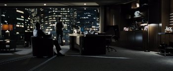 Movie still from “Max Payne” (2008), directed by John Moore – A man standing at a desk in an office at night; Wide shot, High angle