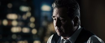 Movie still from “Max Payne” (2008), directed by John Moore – A person wearing a suit and tie; Close Up shot, Over the shoulder angle