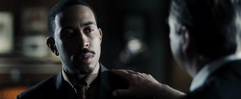 Movie still from “Max Payne” (2008), directed by John Moore – A man holding a cell phone up to his ear; Close Up shot, Over the shoulder angle