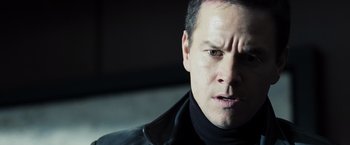 Movie still from “Max Payne” (2008), directed by John Moore – A person wearing a black jacket; Close Up shot, Over the shoulder angle