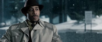 Movie still from “Max Payne” (2008), directed by John Moore – A man wearing a hat and a trench coat in the snow; Close Up shot, Low angle