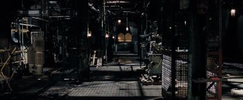 Movie still from “Max Payne” (2008), directed by John Moore – An industrial building with a lot of lights hanging from the ceiling; Extreme Wide shot, High angle