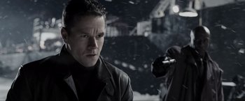 Movie still from “Max Payne” (2008), directed by John Moore – A man standing in front of a camera in the snow; Close Up shot, Over the shoulder angle