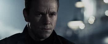 Movie still from “Max Payne” (2008), directed by John Moore – A person wearing a black shirt; Close Up shot, Over the shoulder angle