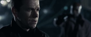 Movie still from “Max Payne” (2008), directed by John Moore – A person wearing a black jacket; Close Up shot, Over the shoulder angle