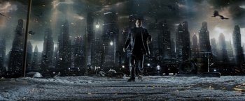 Movie still from “Max Payne” (2008), directed by John Moore – A man is walking in the rain in a city; Wide shot, Low angle