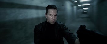 Movie still from “Max Payne” (2008), directed by John Moore – A man in a black jacket is looking at the camera; Close Up shot, Overhead angle