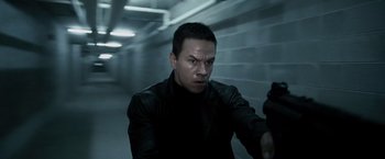 Movie still from “Max Payne” (2008), directed by John Moore – A man in a black leather jacket holding a gun; Close Up shot, High angle