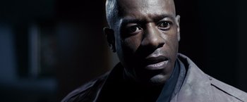 Movie still from “Max Payne” (2008), directed by John Moore – A man's face in the dark; Close Up shot, Low angle