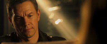 Movie still from “Max Payne” (2008), directed by John Moore – A person wearing a black jacket; Close Up shot, Over the shoulder angle