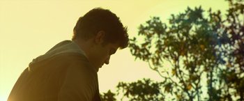 Movie still from “Max Steel” (2016), directed by Stewart Hendler – A young man standing in front of a tree; Close Up shot, Low angle