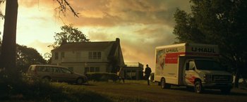 Movie still from “Max Steel” (2016), directed by Stewart Hendler – A couple of people walking in front of a white truck; Extreme Wide shot, Low angle