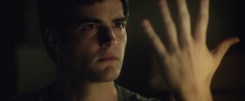 Movie still from “Max Steel” (2016), directed by Stewart Hendler – A man's face with his hand raised up; Close Up shot, Over the shoulder angle