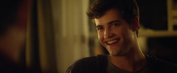 Movie still from “Max Steel” (2016), directed by Stewart Hendler – A young man smiling for the camera; Close Up shot, Over the shoulder angle