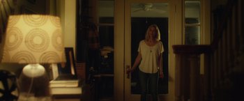 Movie still from “Max Steel” (2016), directed by Stewart Hendler – A woman standing in front of a mirror in a room; Medium shot, Over the shoulder angle