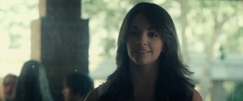 Movie still from “Max Steel” (2016), directed by Stewart Hendler – A beautiful young lady smiling for the camera; Close Up shot, Over the shoulder angle