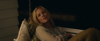 Movie still from “Max Steel” (2016), directed by Stewart Hendler – A woman sitting in a chair with her arms folded over her chest; Close Up shot, Over the shoulder angle