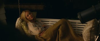 Movie still from “Max Steel” (2016), directed by Stewart Hendler – A woman laying on a bench with a blanket; Medium shot, High angle