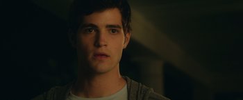 Movie still from “Max Steel” (2016), directed by Stewart Hendler – A young man is looking into the camera; Close Up shot, Over the shoulder angle