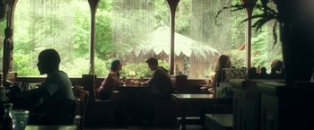 Movie still from “Max Steel” (2016), directed by Stewart Hendler – A man and a woman are sitting at a table; Wide shot, High angle