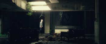 Movie still from “Max Steel” (2016), directed by Stewart Hendler – A man standing in the middle of an abandoned building; Extreme Wide shot, Low angle