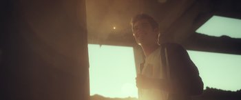 Movie still from “Max Steel” (2016), directed by Stewart Hendler – A young man standing next to a window in a room; Medium shot, Low angle