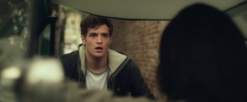 Movie still from “Max Steel” (2016), directed by Stewart Hendler – A man looking into a mirror while wearing a jacket; Close Up shot, Over the shoulder angle