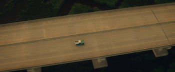 Movie still from “Max Steel” (2016), directed by Stewart Hendler – An aerial view of a truck driving on a highway; Extreme Wide shot, Overhead angle