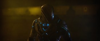 Movie still from “Max Steel” (2016), directed by Stewart Hendler – A man in a black suit with blue lights around it; Medium shot, Low angle