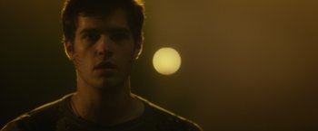 Movie still from “Max Steel” (2016), directed by Stewart Hendler – A young man standing in front of a yellow light; Close Up shot, Over the shoulder angle