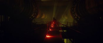 Movie still from “Max Steel” (2016), directed by Stewart Hendler – A person is standing on some stairs in a dark room; Extreme Wide shot, High angle