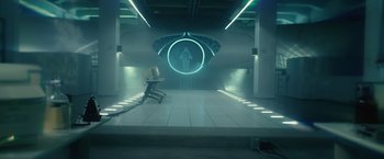 Movie still from “Max Steel” (2016), directed by Stewart Hendler – A room that has a chair in the middle of the floor; Wide shot, High angle