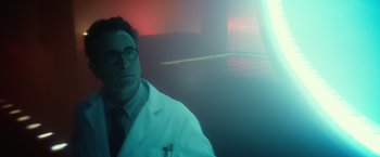 Movie still from “Max Steel” (2016), directed by Stewart Hendler – A man wearing a lab coat and a tie; Medium shot, Low angle