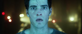 Movie still from “Max Steel” (2016), directed by Stewart Hendler – A young man stares into the camera with an intense look on his face; Close Up shot, Low angle