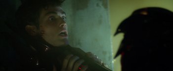 Movie still from “Max Steel” (2016), directed by Stewart Hendler – A young man holding a remote in his hand; Close Up shot, Low angle