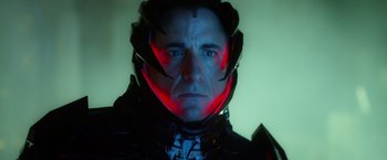 Movie still from “Max Steel” (2016), directed by Stewart Hendler – A man wearing a helmet with red lights around it; Close Up shot, Low angle