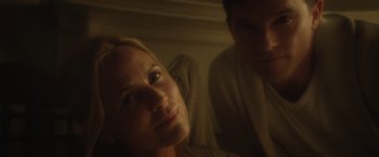 Movie still from “Max Steel” (2016), directed by Stewart Hendler – A woman and a man sitting next to each other in a room; Close Up shot, Low angle