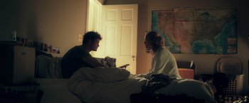 Movie still from “Max Steel” (2016), directed by Stewart Hendler – A man and a woman sitting on a bed talking to each other; Medium shot, Over the shoulder angle