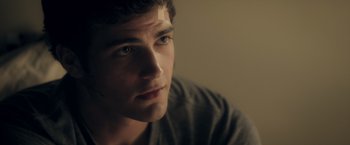 Movie still from “Max Steel” (2016), directed by Stewart Hendler – A young man is looking into the distance; Close Up shot, Over the shoulder angle