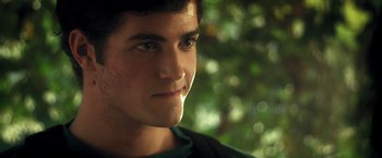Movie still from “Max Steel” (2016), directed by Stewart Hendler – A young man's face in front of trees; Close Up shot, Over the shoulder angle